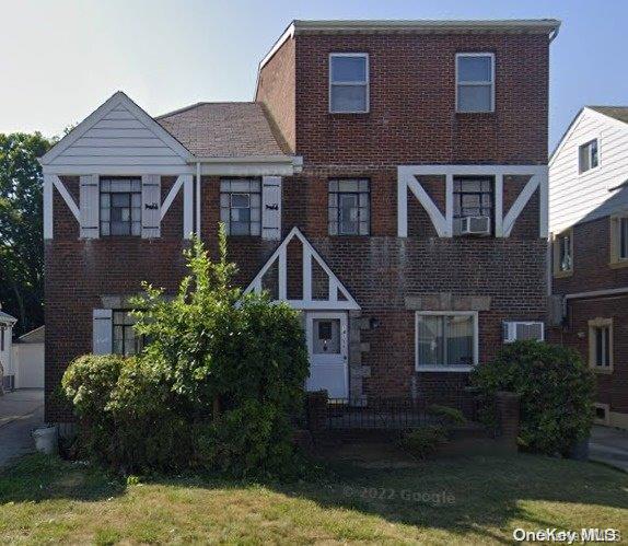 view of front of home with a front yard and cooling unit