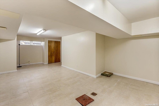 basement with light tile patterned flooring