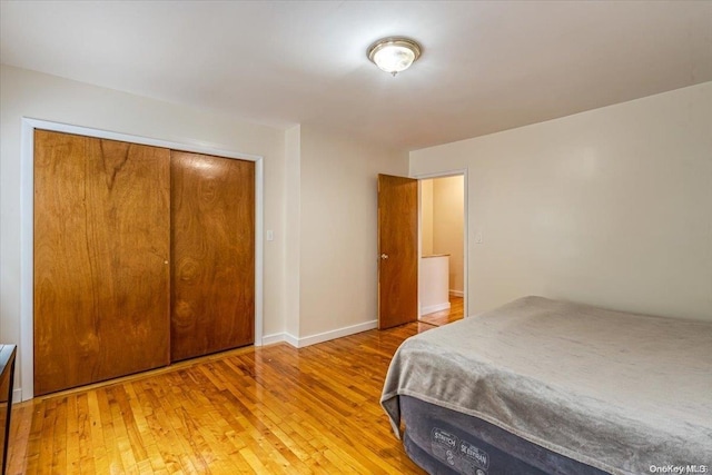 bedroom with a closet and hardwood / wood-style flooring