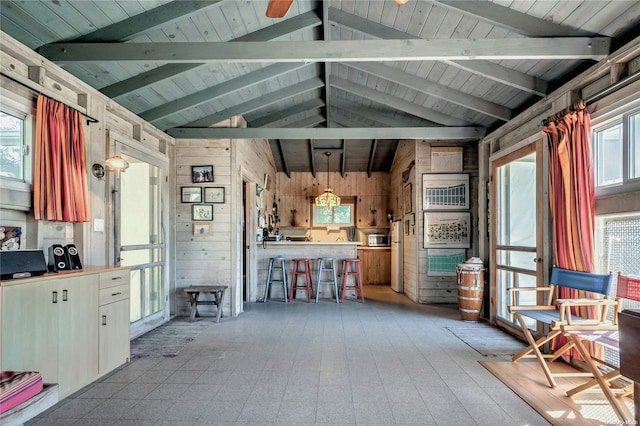 misc room featuring wood ceiling, wood walls, and lofted ceiling with beams