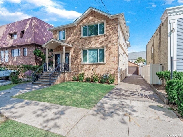 view of front of property with a garage and a front lawn