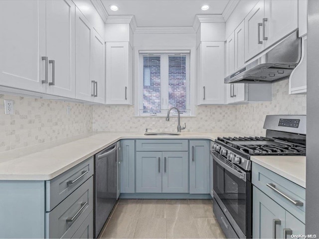 kitchen featuring white cabinets, appliances with stainless steel finishes, ornamental molding, and sink