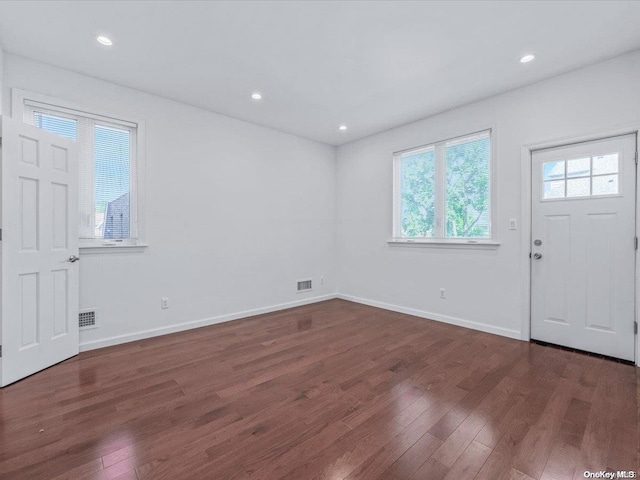 foyer entrance with dark hardwood / wood-style floors