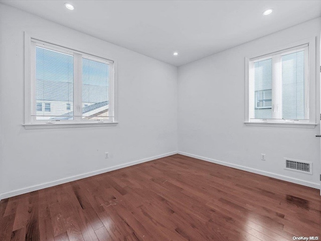 unfurnished room with dark hardwood / wood-style flooring