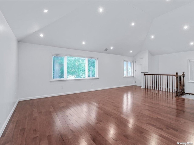 interior space featuring dark wood-type flooring and vaulted ceiling