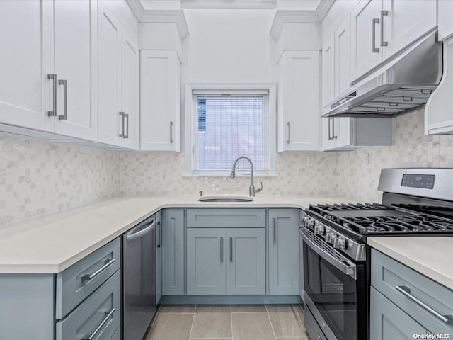 kitchen with gray cabinets, stainless steel appliances, white cabinetry, and sink