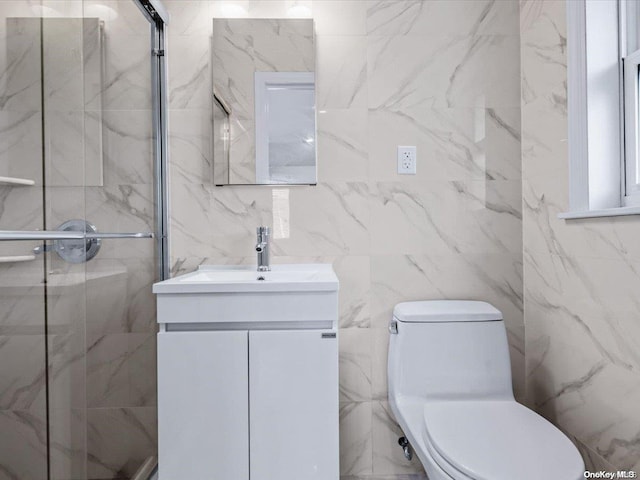 bathroom featuring walk in shower, vanity, toilet, and tile walls