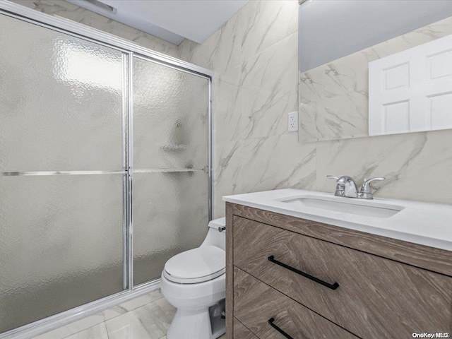 bathroom with vanity, toilet, tile walls, walk in shower, and tasteful backsplash