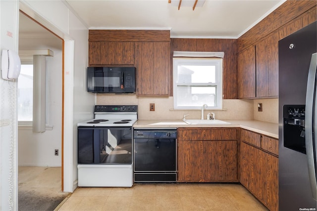 kitchen featuring decorative backsplash, light carpet, sink, and black appliances