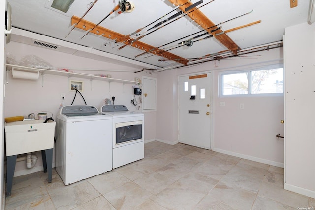 washroom with washer and clothes dryer and sink