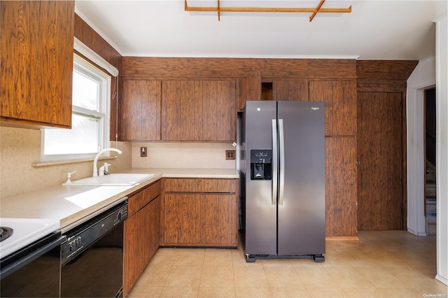 kitchen with stainless steel fridge, sink, and black dishwasher