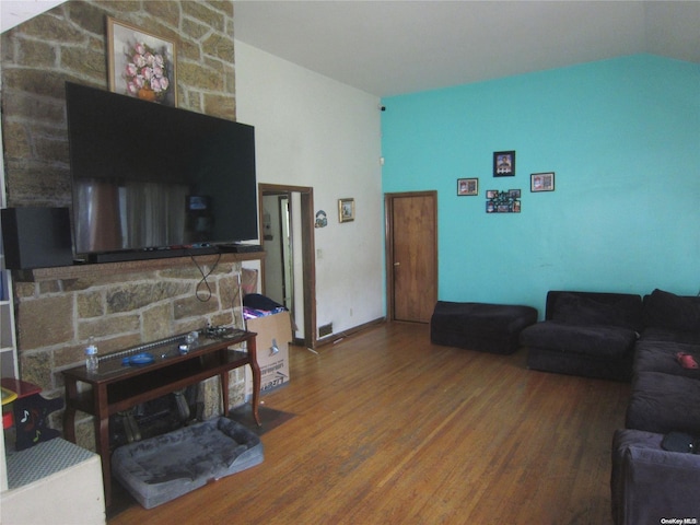 living room featuring lofted ceiling and wood finished floors