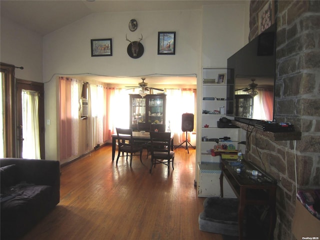 dining area with ceiling fan, vaulted ceiling, and wood finished floors