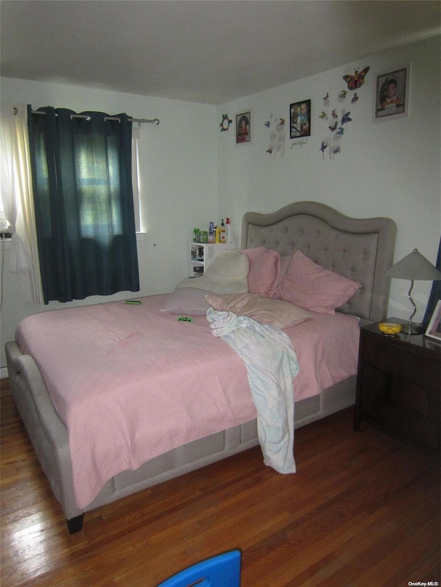 bedroom featuring wood finished floors