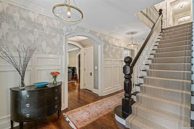 foyer entrance featuring dark hardwood / wood-style floors and ornamental molding