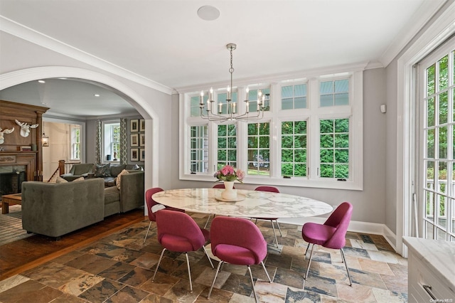 dining area with a notable chandelier and crown molding