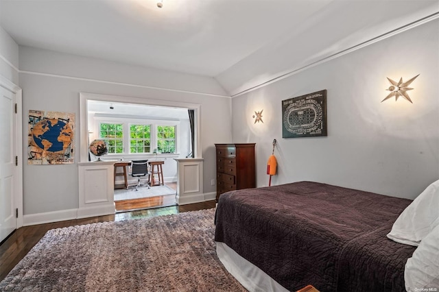 bedroom featuring dark wood-type flooring and vaulted ceiling