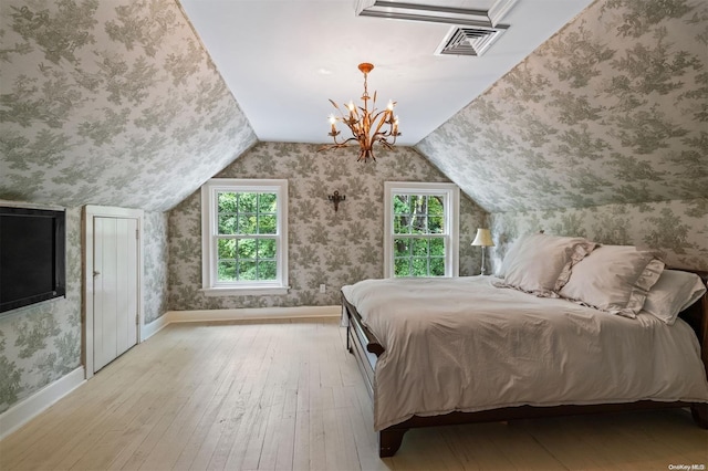 bedroom with light hardwood / wood-style floors, vaulted ceiling, and multiple windows