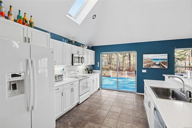 kitchen with stainless steel appliances, white cabinetry, plenty of natural light, and sink