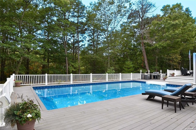 view of swimming pool featuring a wooden deck