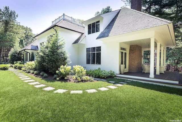 rear view of house with a lawn