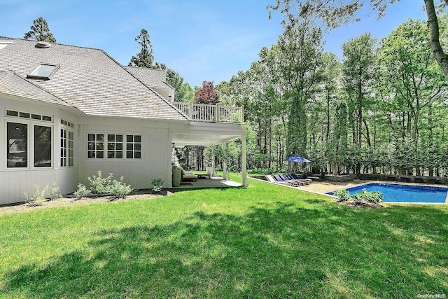 view of yard featuring a balcony and a patio