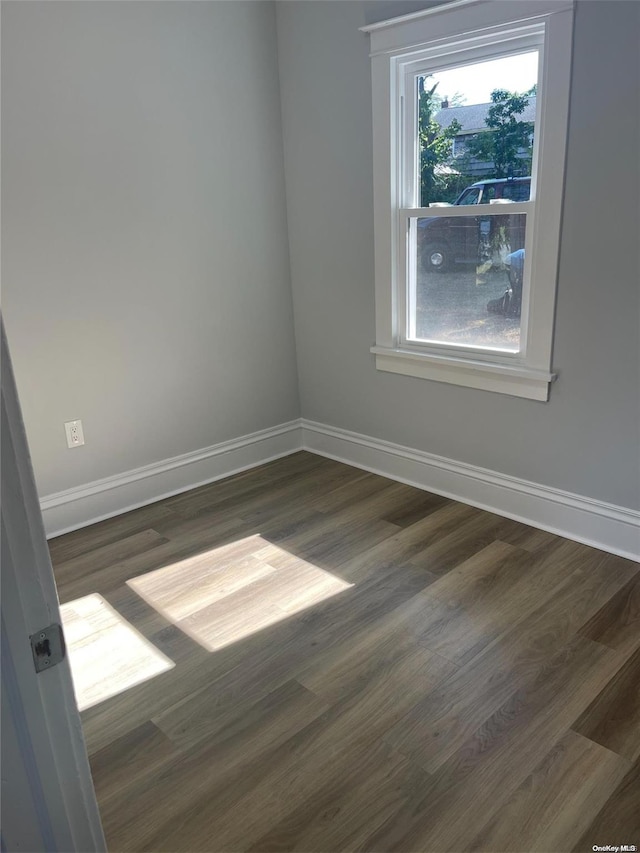 empty room featuring dark wood-type flooring