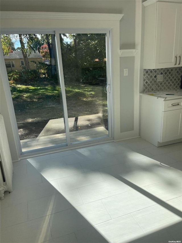 doorway to outside featuring light tile patterned floors