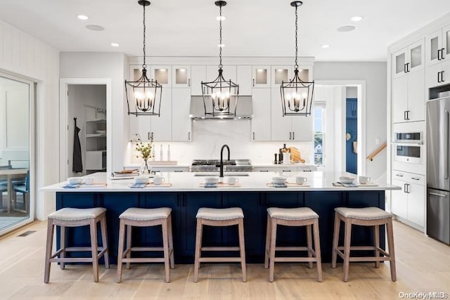 9 Sienna/ Ct, Dix Hills, NY 11746 - kitchen featuring a chandelier, high quality fridge, wall chimney range hood, light countertops, and white cabinetry