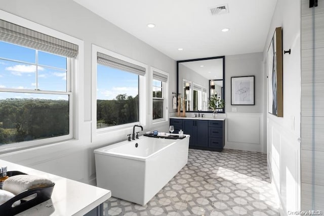 9 Sienna/ Ct, Dix Hills, NY 11746 - bathroom with vanity, tile patterned floors, a freestanding bath, a wainscoted wall, and recessed lighting