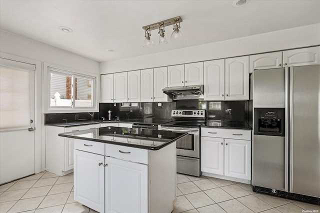 kitchen with tasteful backsplash, white cabinets, and appliances with stainless steel finishes