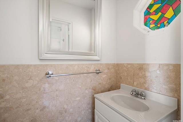 bathroom featuring vanity and tile walls