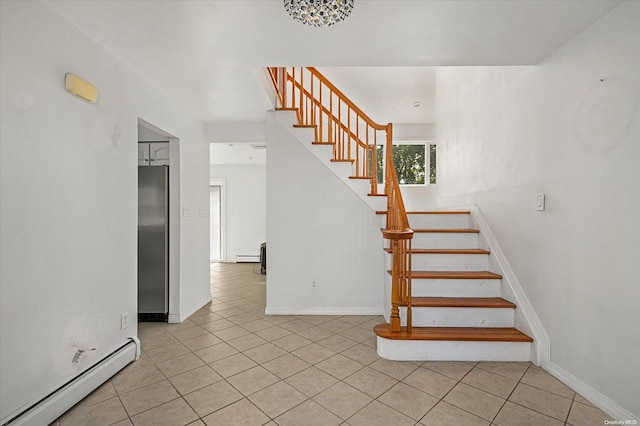 stairs with a baseboard radiator and tile patterned floors