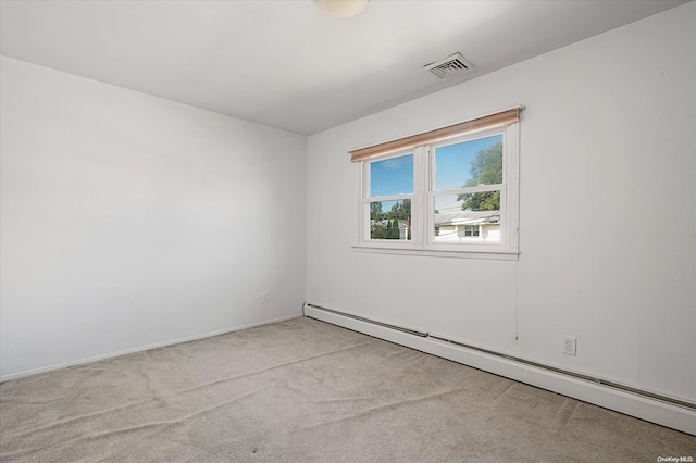 empty room with light carpet and a baseboard radiator