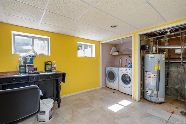 laundry area with a wealth of natural light, washer and dryer, and gas water heater