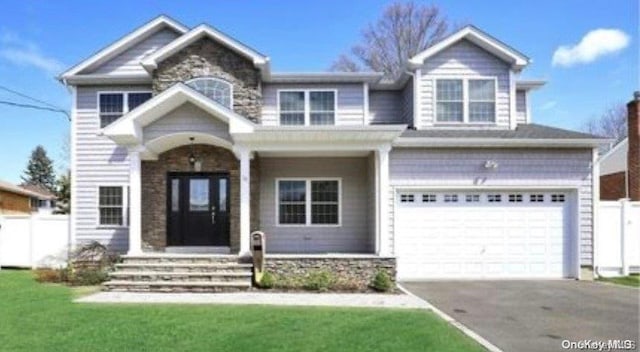 view of front facade with a garage and a front yard