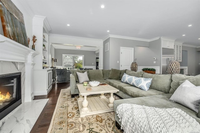 living room with a premium fireplace and crown molding