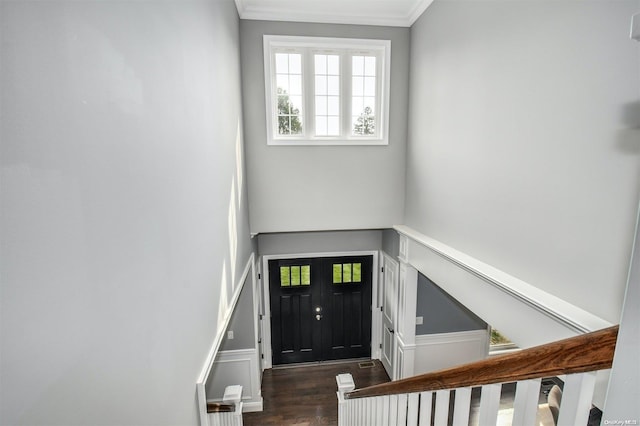 stairway featuring wood-type flooring and ornamental molding