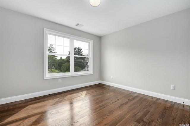 spare room featuring dark hardwood / wood-style floors