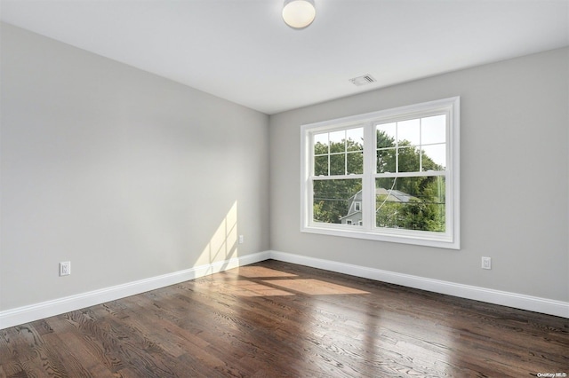 spare room featuring dark hardwood / wood-style flooring