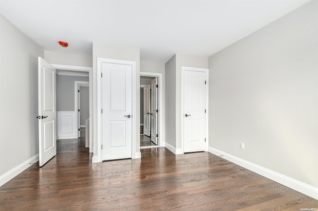 unfurnished bedroom featuring dark hardwood / wood-style flooring