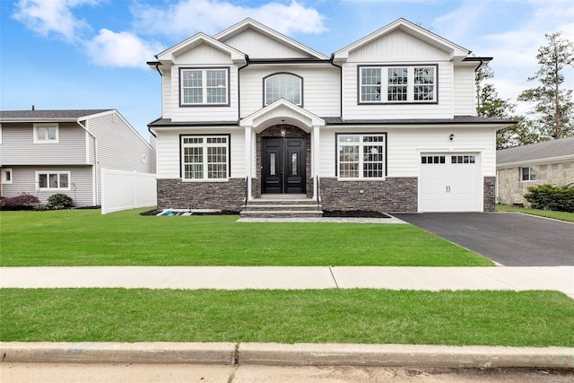 craftsman-style house featuring a front lawn and a garage