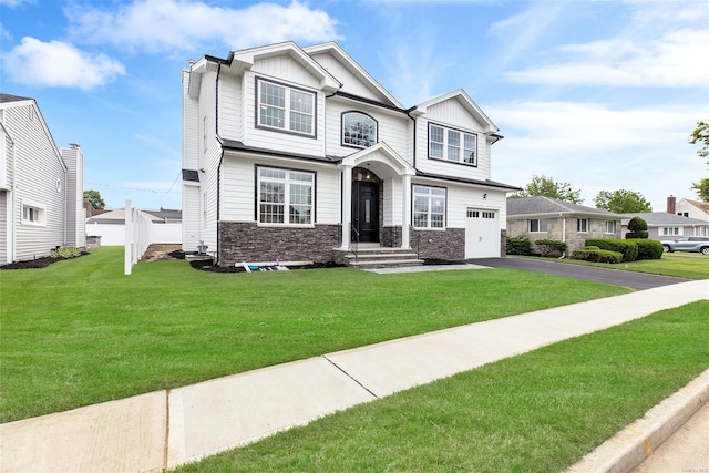 view of front of property with a front lawn and a garage