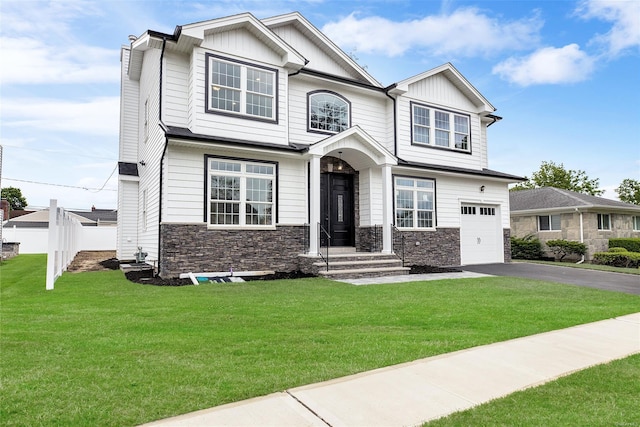 craftsman-style home with a front yard and a garage