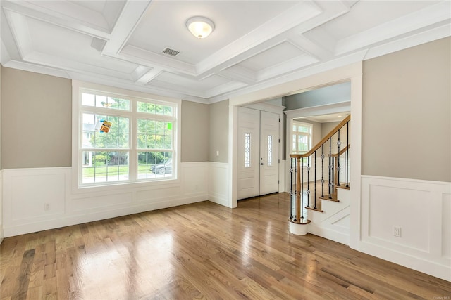 foyer with beam ceiling, wood-type flooring, crown molding, and coffered ceiling