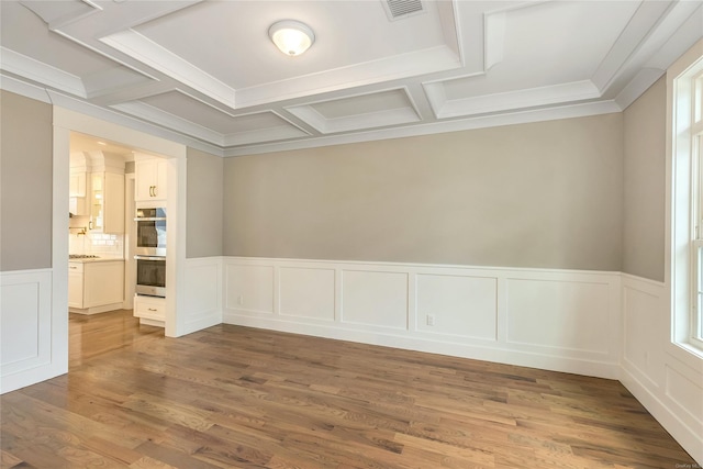 unfurnished room with wood-type flooring, crown molding, and coffered ceiling