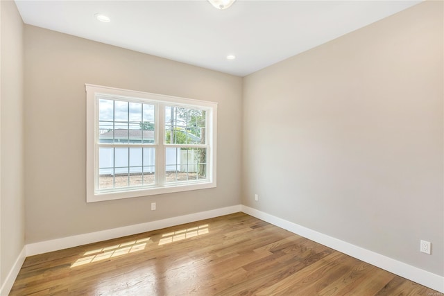 unfurnished room with wood-type flooring