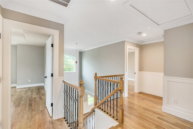 corridor with crown molding and light hardwood / wood-style flooring