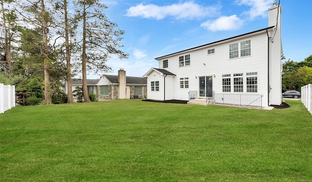 back of house featuring a yard