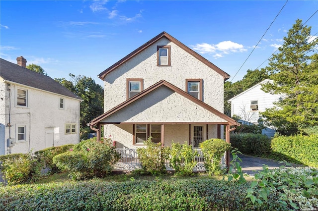 back of property with covered porch